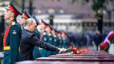 Presiden Rusia, Vladimir Putin meletakkan bunga di tengah hujan lebat saat upacara kehormatan untuk memperingati invasi Nazi Jerman pada 1941 di Benteng Kremlin, Moskow, Kamis (22/6). (Alexei Druzhinin/Sputnik, Kremlin Pool Photo via AP)