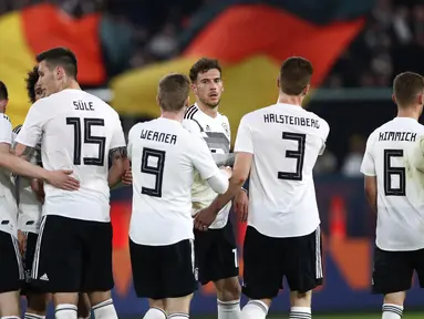 Para pemain Jerman merayakan gol yang dicetak oleh Leon Goretzka ke gawang Serbia  pada laga persahabatan di Stadion Volkswagen, Rabu, (20/3). Jerman ditahan imbang 1-1 oleh Serbia. (AFP/Chirstian Charisius)