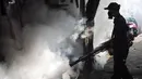 Petugas melakukan pengasapan atau fogging untuk membasmi nyamuk demam berdarah dengue (DBD) di perumahan warga di Jakarta, Sabtu (11/4/2020). Fogging dilakukan sebagai langkah pengendalian vektor nyamuk DBD. (Liputan6.com/JohanTallo)