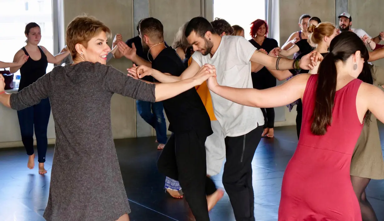 Keceriaan peserta saat belajar tarian tradisional Arab Dabke di Berlin, Jerman, Minggu (15/4). (AP Photo/Jona Kallgren)