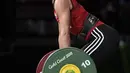 Holly Knowles dari Wales bersiap mengangkat beban saat berkompetisi dalam angkat besi wanita 63 kg selama Commonwealth Games 2018 di Gold Coast, Australia (7/4). (AFP Photo/William West)