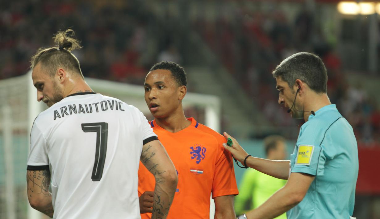 Wasit Undiano Mallenco mencoba menenangkan adu mulut antara bek Belanda, Kenny Tete, dengan pemain Austria, Marco Arnautovic. (Bola.com/Reza Khomaini)