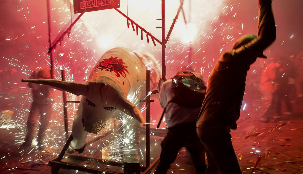 Sejumlah peserta bermandikan kembang api saat perayaan San Juan de Dios di Tultepec, Meksiko (8/3). Acara ini digelar setiap tahun, dan menjadi daya tarik wisatawan. (AFP Photo/Ronaldo Skemidt)
