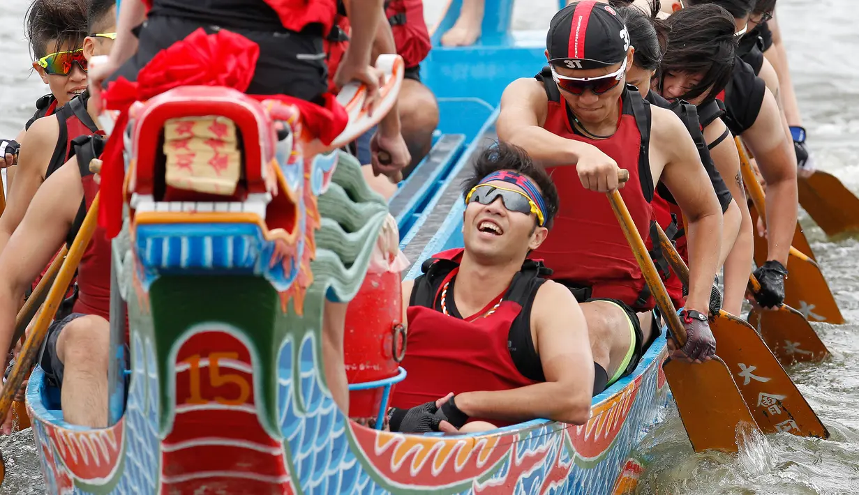 Seorang peserta bereaksi seusai mengikuti perlombaan tradisional China, Dragon Boat di Taipei, taiwan, Minggu (28/5). Perlombaan perahu naga ini untuk mengenang kematian penyair Qu Yuan yang tewas tenggelam pada 278 SM. (AP Photo/Chiang Ying-ying)