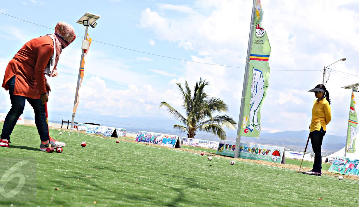 Atlet dan wisatawan bermain olahraga gateball di Pantai Talise, Palu, Sulteng, Selasa (8/3). Event olahraga itu diadakan untuk memeriahkan acara melihat Gerhana Matahari Total bersama yang akan diadakan Rabu (9/3) besok. (Liputan6.com/Immanuel Antonius)
