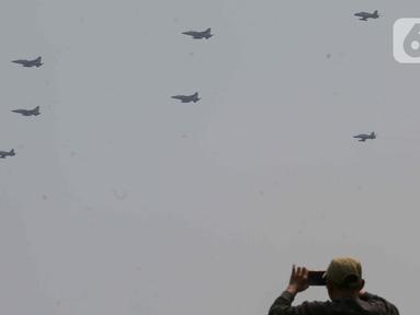 Pesawat KT-1 Wong Bee yang tergabung dalam Jupiter Aerobatic Team (JAT) TNI AU menampilkan atraksi aerobatik saat peringatan Hari Ulang Tahun (HUT) ke-79 Tentara Nasional Indonesia (TNI) di Lapangan Silang Monumen Nasional (Monas), Gambir, Jakarta, Sabtu (5/10/2024). (Liputan6.com/Herman Zakharia)