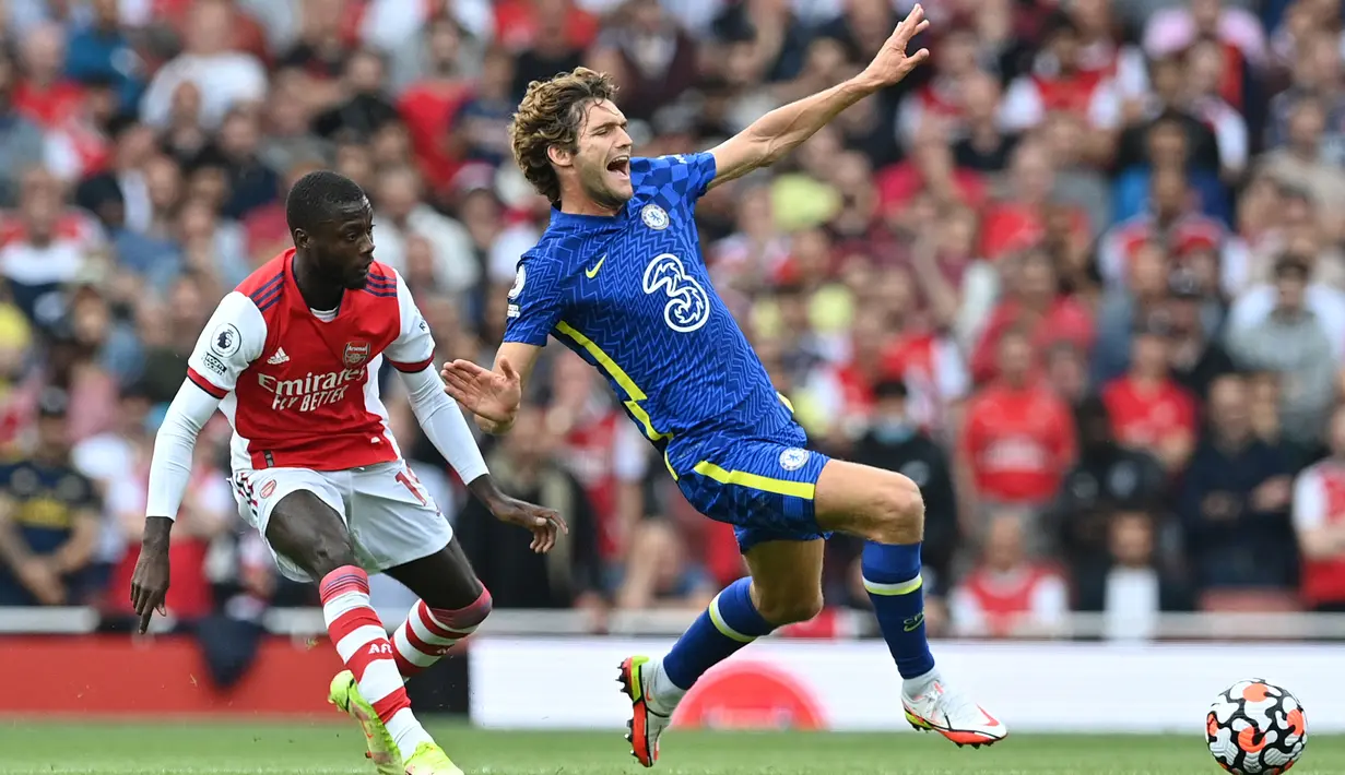Pemain Arsenal Nicolas Pepe (kiri) melakukan pelanggaran terhadap pemain Chelsea Marcos Alonso (kanan) pada pertandingan Liga Inggris di Emirates Stadium, London, Inggris, 22 Agustus 2021. Chelsea menang 2-0. (JUSTIN TALLIS/AFP)
