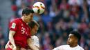 Striker Bayern Munchen, Robert Lewandowski duel udara dengan pemain Stuttgart, Toni Sunjic pada laga Bundesliga di Stadion Allianz Arena, Jerman, Sabtu (7/11/2015). (Reuters/Michael Dalder)