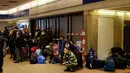 Orang-orang menunggu di pusat pengungsi dari Ukraina di Messe di Berlin, Jerman pada 11 Maret 2022. Badan PBB untuk urusan pengungsi (UNHCR) mengatakan setidaknya 2,5 juta orang telah meninggalkan Ukraina, dengan lebih dari setengahnya sekarang di Polandia. (Odd ANDERSEN / AFP)