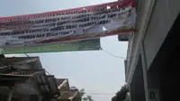 Spanduk imbuan soal penyelenggaraan Pilkades di Garut yang diduga melecehkan lambang Pancasila. (Liputan6.com/Jayadi Supriadin)