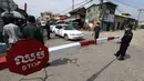 Petugas kepolisian setempat berjaga di jalan yang diblokir dekat bandara Internasional Phnom Penh di Phnom Penh, Kamis (15/4/2021). Pemimpin Kamboja memutuskan untuk lockdown atau karantina Phnom Penh selama dua minggu mulai Kamis (15/4) menyusul kenaikan tajam kasus COVID-19. (AP Photo/Heng Sinith)
