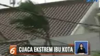 Sampah daun dan patahan atap rumah warga terbawa terbang oleh hembusan angin.