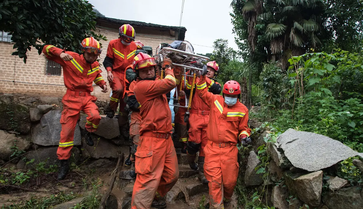 Tim penyelamat menggotong seorang wanita lanjut usia yang berhasil dikeluarkan dari puing-puing di Yuanshan, sebuah desa di Kota Dahe yang berada di Wilayah Huangmei, Provinsi Hubei, China tengah (8/7/2020). (Xinhua/Xiao Yijiu)