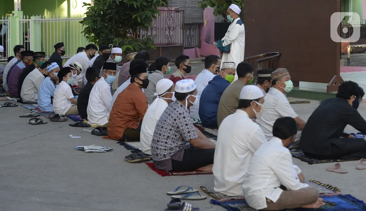 Imam menyampaikan khotbah saat pelaksanaan salat Idul Fitri berjemaah di pelataran Masjid Al Kahfi Griya Pamulang 2, Parakan, Pamulang, Tangerang Selatan, Banten, Minggu (24/5/2020). Di tengah pandemi COVID-19, jemaah yang hadir mengenakan masker untuk mencegah penularan. (merdeka.com/Dwi Narwoko)