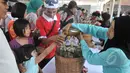 Sejumlah bocah meminta jamu saat peringatan Hari Konsumen Nasional di Lapangan Parkir Gedung Sarinah, Jakarta, Minggu (10/5/2015). (Liputan6.com/Herman Zakharia) 