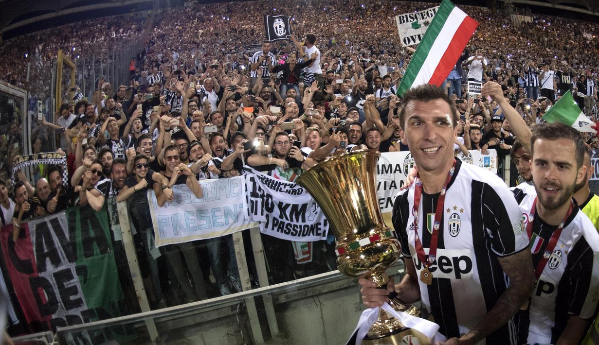 Pemain Juventus, Mario Mandzukic (kiri) dan Miralem Pjanic merayakan kemenangan bersama fans pada final Copaa Italia 2016-2017  di Roma Olympic stadium, (17/5/2017). Juventus menang 2-0. (EPA/Claudio Peri)