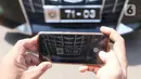 Seseorang mengambil gambar plat nomor khusus anggota DPR yang terparkir di Kompleks Parlemen, Jakarta, Selasa (25/5/2021). Wakil Ketua Mahkamah Kehormatan DPR Habiburokhman menjelaskan penggunaan plat nomor khusus tersebut hanya menyempurnakan penggunaan atribut logo DPR. (Liputan6.com/Angga Yuniar)