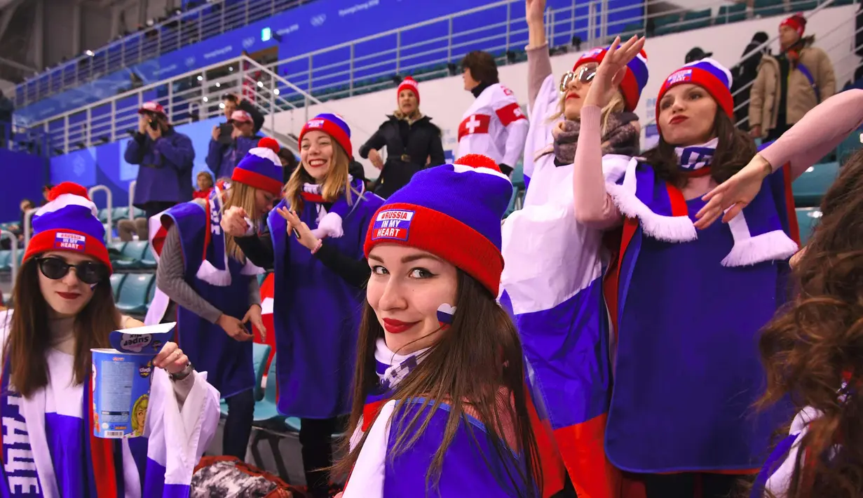 Fans wania Rusia bersorak dalam pertandingan hoki es final perempat final antara Rusia dan Swiss saat Olimpiade Musim Dingin Pyeongchang 2018 di Pusat Hoki Kwandong di Gangneung (17/2). (AFP Photo/Jung Yeon-Je)