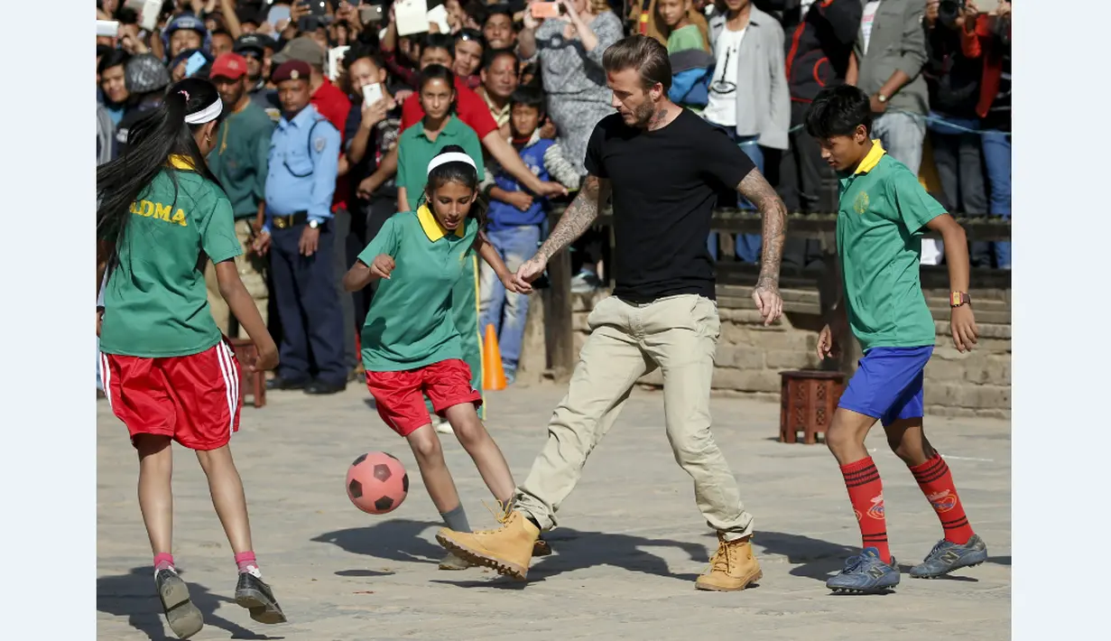 David Beckham bermain bola dengan anak-anak dalam pertandingan amal bersama UNICEF di kota tua Bhaktapur, Nepal, (6/11/2015). (Reuters/Navesh Chitrakar)