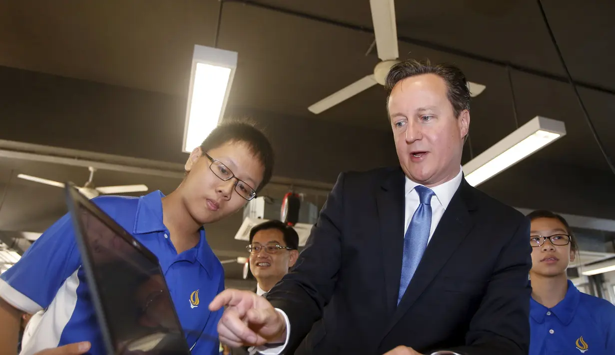 David Cameron berbicara dengan siswa saat melihat perangkat lunak untuk printer 3D di Sekolah Menengah Commonwealth, Singapura, Rabu  (29/7/2015). Cameron menunjukkan pentingnya Asia Tenggara sebagai tempat usaha yang berpotensi. (REUTERS/Edgar Su)