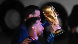 Kapten Argentina Lionel Messi (kiri) memegang Trofi Piala Dunia 2022 bersama pelatih Lionel Scaloni setibanya di Bandara Internasional Ezeiza di Ezeiza, provinsi Buenos Aires, Argentina (20/12/2022). Ini adalah gelar juara Piala Dunia ketiga dalam sejarahnya. Terakhir kali Argentina juara pada 1986 alias 36 tahun lalu. Argentina yang diperkuat Diego Maradona mengandaskan Jerman Barat 3-2 dalam final Piala Dunia di Meksiko. (AFP/Luis Robayo)