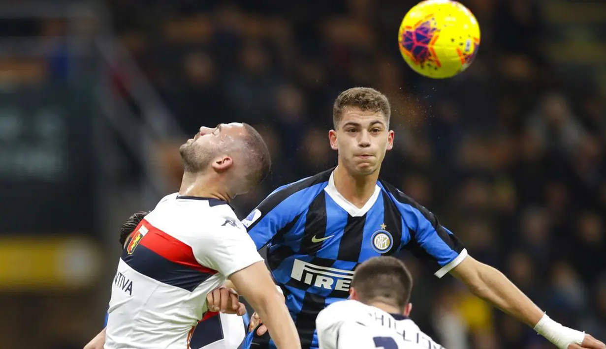 Pemain Inter Milan, Sebastiano Esposito, duel udara dengan pemain Genoa, Davide Biraschi, pada laga Serie A 2019 di Stadion San Siro, Sabtu (21/12). Inter Milan menang 4-0 atas Genoa. (AP/Luca Bruno)