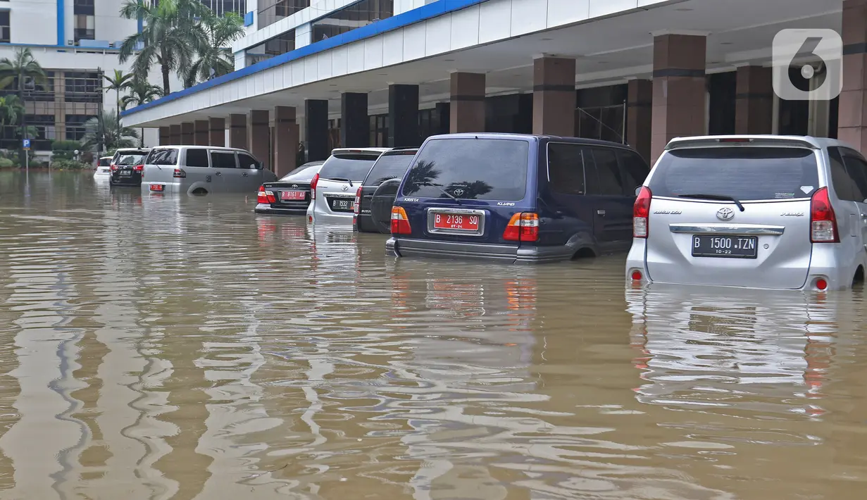 Banjir merendam sejumlah kendaraan di halaman Kantor Direktorat Jenderal Bea dan Cukai, Jakarta, Selasa (25/2/2020). Hujan yang mengguyur Jakarta sejak dini hari tadi membuat halaman Kantor Direktorat Jenderal Bea dan Cukai terendam banjir. (Liputan6.com/Herman Zakharia)