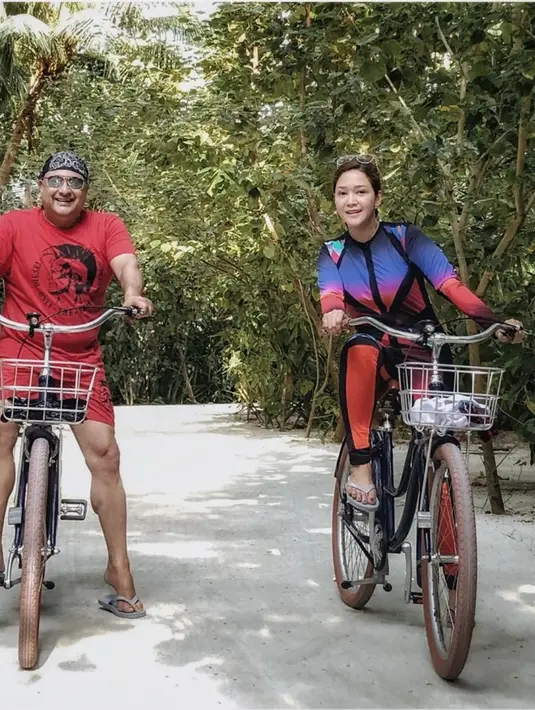 Maia Estianty tanpa balutan makeup sangat menikmati liburannya bersama suami. Keduanya nampak romantis, yang terlihat dari sama-sama mengenakan pakaian santai sambil bersepeda di area sekitar tempat berlibur. (Liputan6.com/IG/maiaestiantyreal)