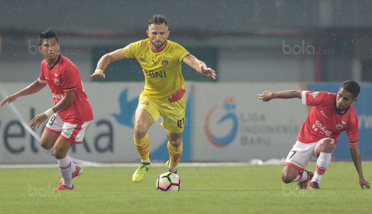 Ilija Spasojevic (tengah) melewati dua pemain Persija Jakarta pada lanjutan Liga 1 2017 di Stadion Patriot Bekasi, Sabtu (12/11/2017). Bhayangkara kalah dari Persija 1-2. (Bola.com/Nicklas Hanoatubun)