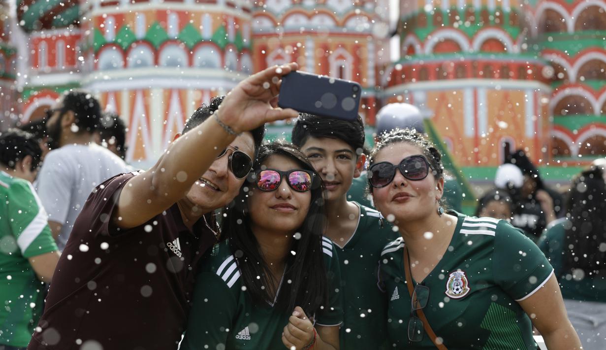 Fans Meksiko melakukan foto selfie saat menyaksikan timnya melawan Skotlandia pada laga uji coba di Azteca Stadium, Meksiko City, (2/6/2018). Meksiko menang 1-0.  (AP/Rebecca Blackwell)