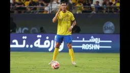 Striker Al Nassr, Cristiano Ronaldo bersiap melepaskan tendangan bebas ke gawang Damac pada laga pekan ke-10 Liga Arab Saudi 2023/2024 yang berlangsung di King Saud University Stadium, Riyadh, Sabtu (21/10/2023) malam WIB. (AFP/Fayez Nureldine)