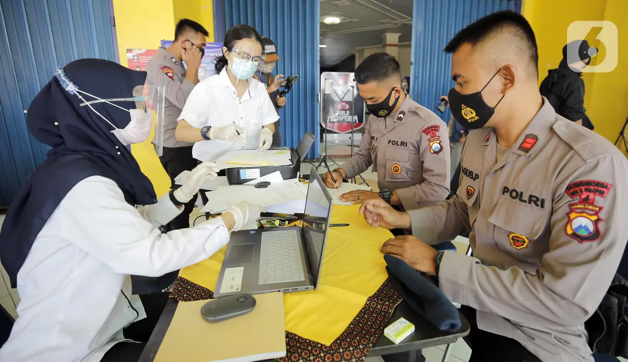 Petugas keamanan melakukan pendaftaran sebelum swab antigen jelang pertandingan sepak bola Piala Menpora 2021 di Stadion Kanjuruhan, Malang, Jawa Timur, Senin (22/3/2021). (Bola.com/Arief Bagus)