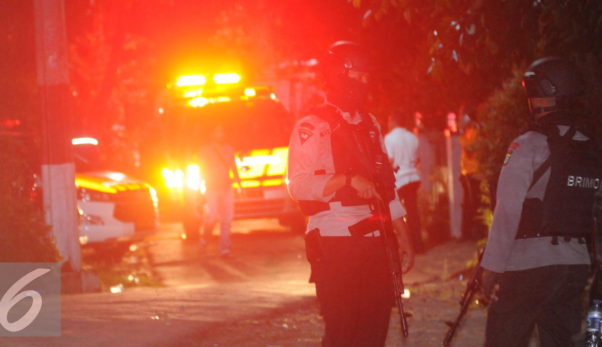 Petugas mengawal ambulan yang berisi mayat terduga teroris di Setu, Tangerang Selatan, Banten, Rabu (21/12). Densus 88 terlibat baku tembak yang akhirnya menewaskan tiga orang terduga teroris. (Liputan6.com/Helmi Afandi)