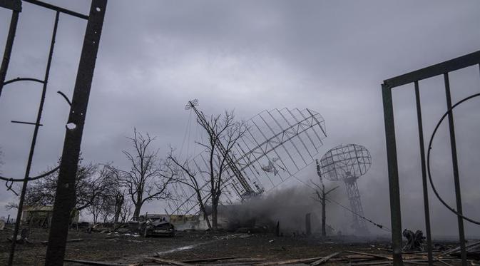 Asap mengepul dari pangkalan pertahanan udara setelah serangan Rusia di Mariupol, Ukraina, Kamis, 24 Februari 2022  akibat serangan Rusia. (AP/Evgeniy Maloletka)