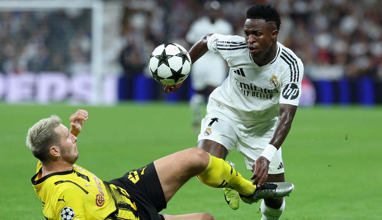 Vinicius Junior tampil beringas dengan memborong tiga gol saat Real Madrid menjamu Borussia Dortmund di Liga Champions. (AFP/Thomas Coex)