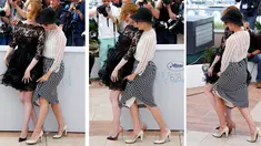 Foto kombinasi Emma Stone (dress hitam) dan Parker Posey saat melindungi baju mereka yang tersibak oleh angin, jelang pemutaran film Irrational Man, di Festival Film Cannes di Perancis, Jumat (15/5/2015). (REUTERS/Yves Herman)