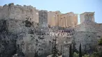 Wisatawan meninggalkan kuil kuno Parthenon di bukit Acropolis di Athena, Yunani pada Rabu (17/7/2024). (Aris Oikonomou / AFP)