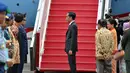 Presiden Jokowi (tengah) didampingi Ibu Negara, Iriana (kanan) dan Wapres Jusuf Kalla bersiap menaiki pesawat kepresidenan untuk melakukan kunjungan kenegaraan  di Bandara Halim Perdanakusuma, Jakarta, Minggu (22/3). (Liputan6.com/Faizal Fanani)