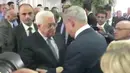 Presiden Palestina Mahmoud Abbas berjabat tangan dengan Perdana Menteri Israel Benjamin Netanyahu pada pemakaman mantan Presiden Israel Shimon Peres di Yerusalem, Jumat (30/9). Peres meninggal dunia karena terkena stroke di usia 93 tahun. (REUTERS)