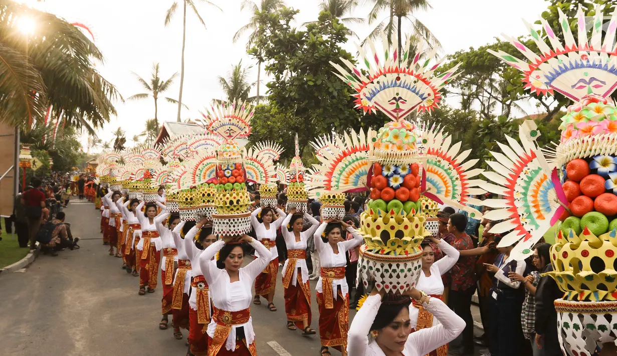 Peserta mengenakan pakaian adat pada karnaval Budaya Bali di kawasan Nusa Dua, Bali, Jumat (12/10). Karnaval tersebut untuk memeriahkan perhelatan Pertemuan Tahunan IMF - World Bank Group 2018 di Bali. (Liputan6.com/Angga Yuniar)