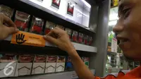 Tim dari PT HM Sampoerna Tbk menempelkan stiker larangan menjual rokok kepada anak di bawah usia 18 tahun, Jakarta, Rabu (30/11). Sampoerna memperkuat komitmen untuk mencegah akses penjualan rokok kepada anak-anak (Liputan6.com/Ferry Pradolo)