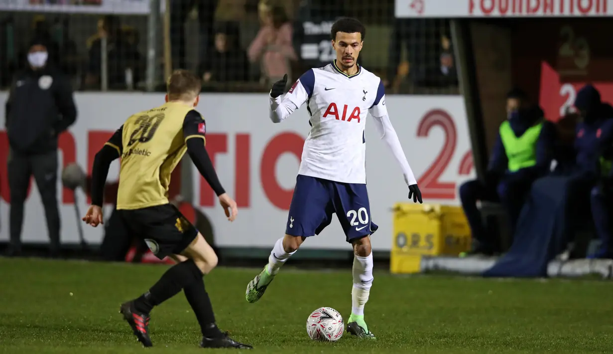Gelandang Tottenham Hotspur Dele Alli (kanan) bersaing dengan gelandang Marine, James Devine (kiri) dalam babak ketiga Piala FA di Rossett Park, Crosby, Inggris, Minggu (10/1/2021). Tottenham Hotspur tanpa ampun menggilas tim semi-profesional, Marine dengan 5-0.  (Clive Brunskill / POOL / AFP)