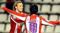 Atletico de Madrid's Kun Aguero celebrates with teammate Diego Forlan after scoring their first goal against Valladolid during a Spanish King Cup second leg football match at Zorrilla stadium in Valladolid, 16 January, 2008. AFP PHOTO/JAVIER SORIANO