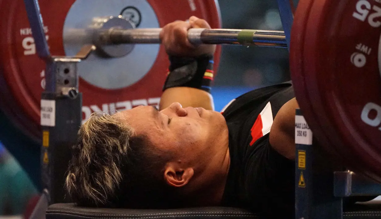 Atlet cabor angkat berat 45 kg putra asal Jawa Barat, Prasetyo Tamim, dalam Pekan Paralimpiade Nasional (Peparnas) XVII di Solo, Jawa Tengah, Selasa (8/10/2024). Tamim berhasil meraih medali emas setelah mengalahkan rekannya satu timnya. (PB PEPARNAS XVII/Andry Prasetyo)