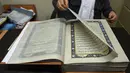 Tampilan Alquran buatan tangan yang dibuat dengan kain sutra di Mourad Khani, Kabul, Afghanistan (19/4). Alquran yang dibuat secara manual ini diharapkan dapat melestarikan tradisi kaligrafi yang telah ada berabad-abad di Afghanistan. (AFP/Wakil Kohsar)