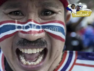 Fans Thailand dengan wajah bergambar bendera negaranya siap meramaikan laga final leg kedua Piala AFF 2016 di Stadion Rajamangala, Thailand. (Bola.com/Ario Yosia)