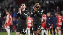 Bek Liverpool asal Skotlandia Andrew Robertson dan bek Liverpool asal Inggris Joe Gomez bertepuk tangan di akhir pertandingan sepak bola fase liga Liga Champions UEFA antara Girona FC dan Liverpool FC di stadion Montilivi di Girona pada 10 Desember 2024.Josep LAGO / AFP