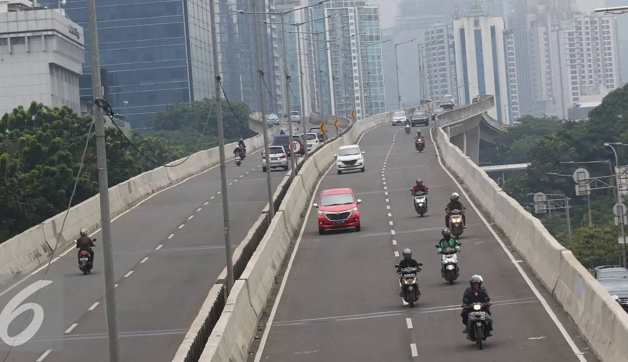 Pengendara sepeda motor melintasi Jalan Layang Non Tol Kampung Melayu-Tanah Abang di Jakarta, Senin (9/1). Minimnya pengawasan membuat pemotor dapat leluasa memasuki jalur khusus roda empat atau lebih tersebut. (Liputan6.com/Immanuel Antonius)