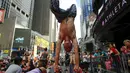Warga berpose ketika melakukan gerakan yoga di tengah jalan saat perayaan Summer Solstice di Hari Yoga Internasional di Times Square, New York, Minggu (21/6/2015). (REUTERS/Eduardo Munoz)