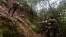 Tentara dari Combat Team Divisi Infanteri 1 Stryker Brigade Angkatan Darat AS menuruni tebing dalam pelatihan perang hutan di Hawaii, 1 Maret 2017. Tentara Angkatan Darat melakukan kursus pelatihan hutan untuk fokus pada Asia dan Pasifik. (AP/Daniel Lin)